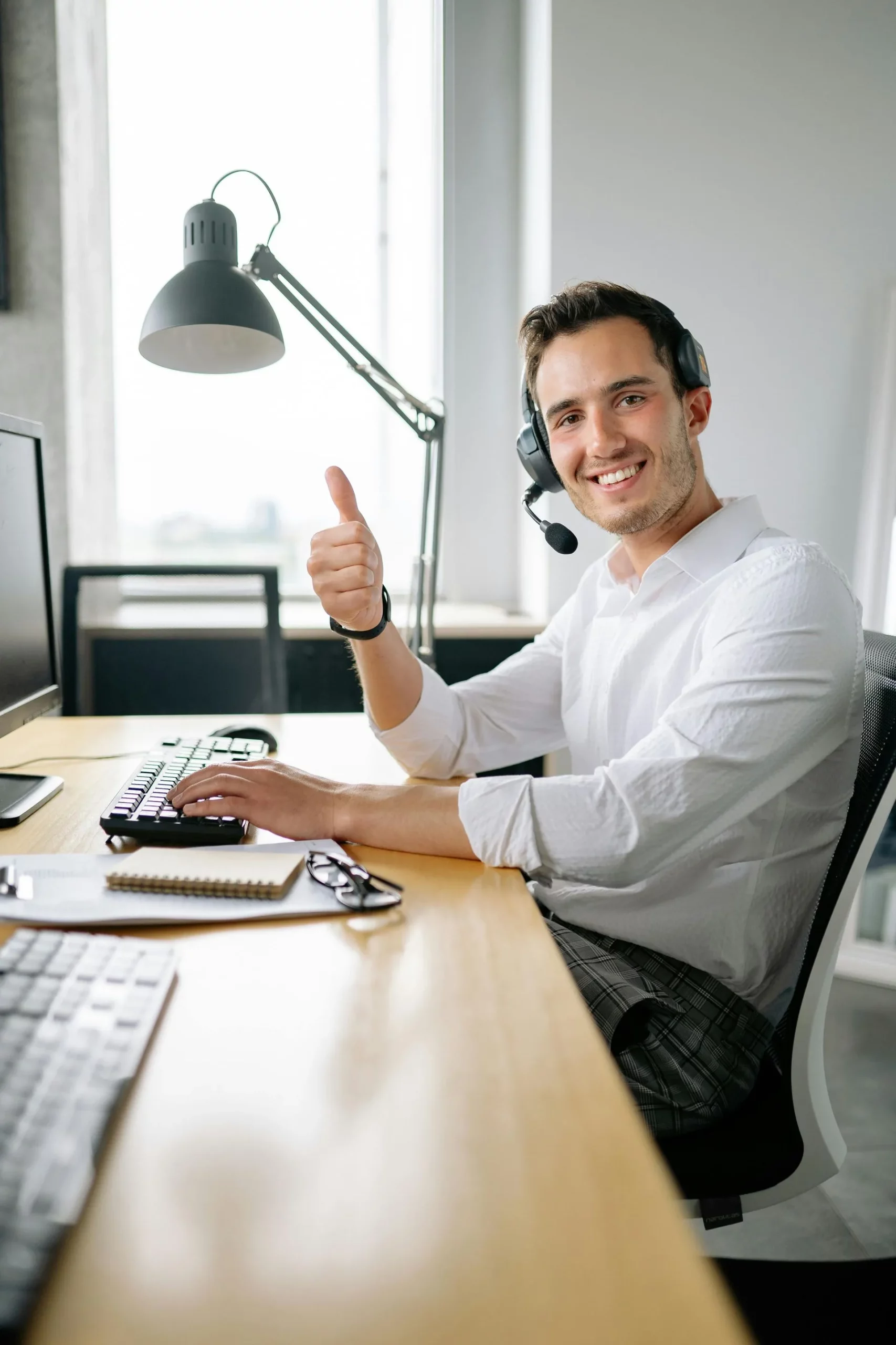 person with headset working on computer